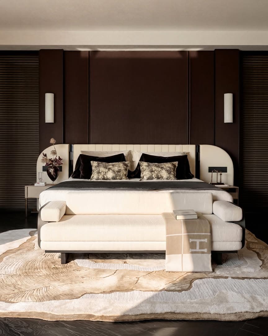 A refined bedroom layered with a sculptural rug