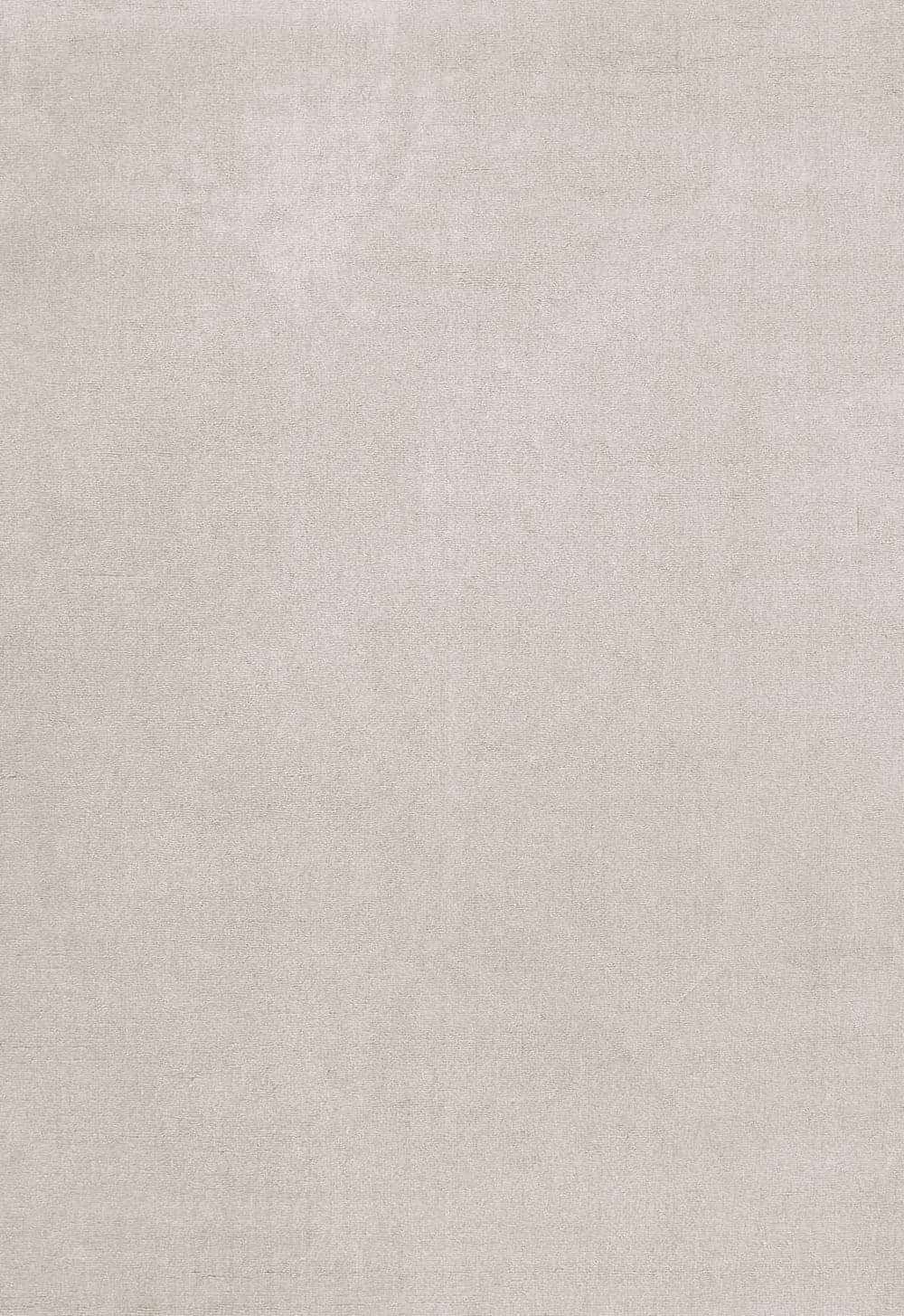 Solid wool oatmeal rug photographed in a styled interior